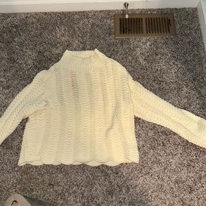 A white/cream color crew neck sweater that is great for the season!